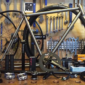 SORE Bikes workshop with a bike frame and parts
